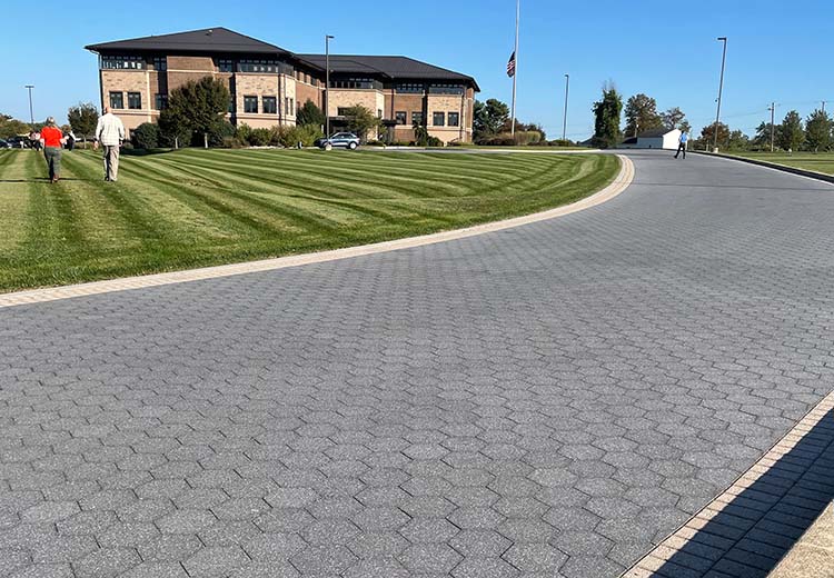 Hanover hexagon asphalt tiles pave a gently curving road next to a golf course