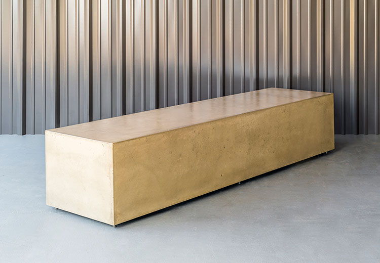Form and Fiber polished concrete box bench in front of a corrugated metal wall