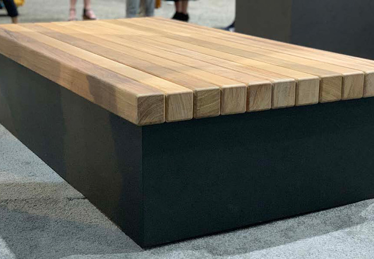 Form and Fiber lounger wood slat bench top on a black metal pedestal base.