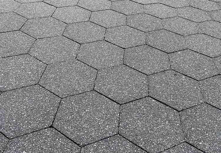 A close-up view of Hanover hexagonal asphalt blocks in a driveway
